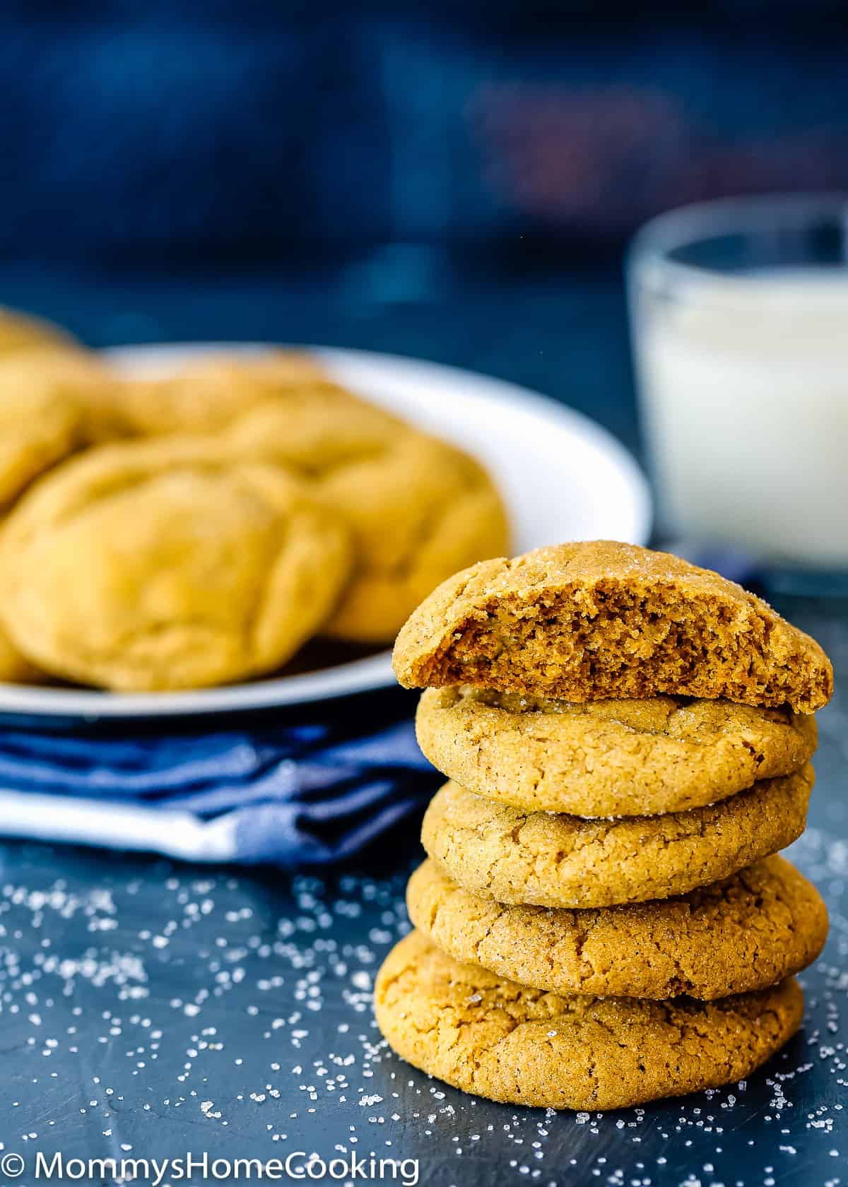 stack of Eggless Pumpkin Snickerdoodles cookies with a glass of milk.