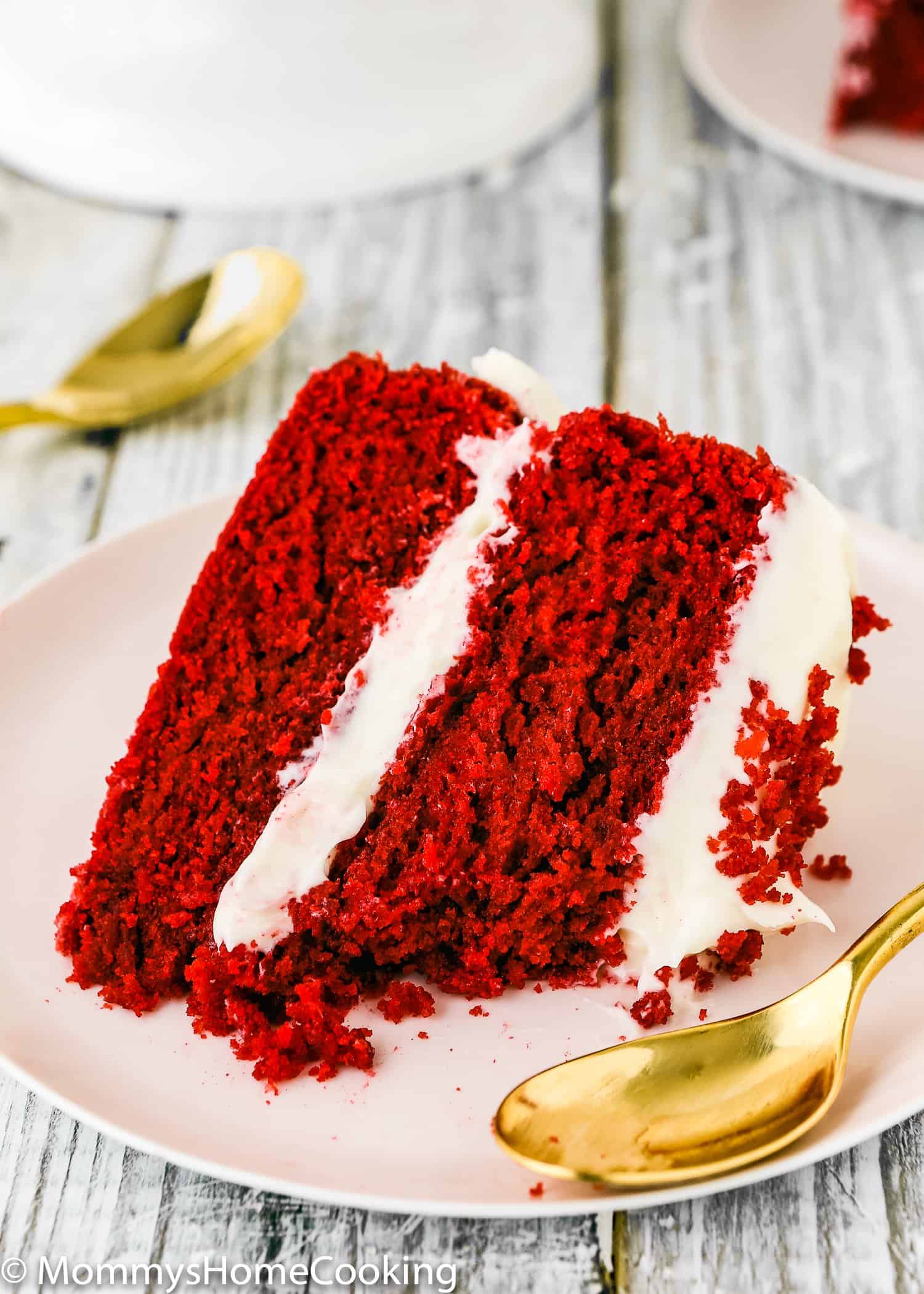 This Eggless Red Velvet Cake is moist, rich, and amazingly tasty! Two lovely layers of tender vibrant sponge red cake with fluffy cream cheese frosting. I promise you will not miss the eggs.  This easy dessert is the perfect showstopper for any occasion. https://mommyshomecooking.com