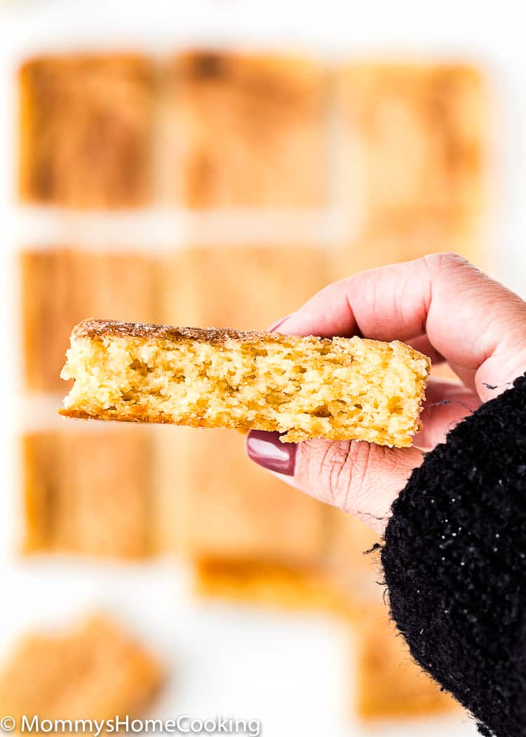 a hand showing the inside of an Eggless Snickerdoodle Bar 