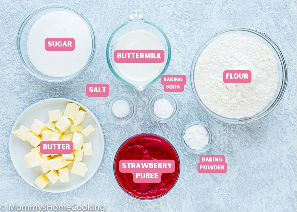 Ingredients needed to make egg-free Strawberry cupcakes over a blue surface with name tags.