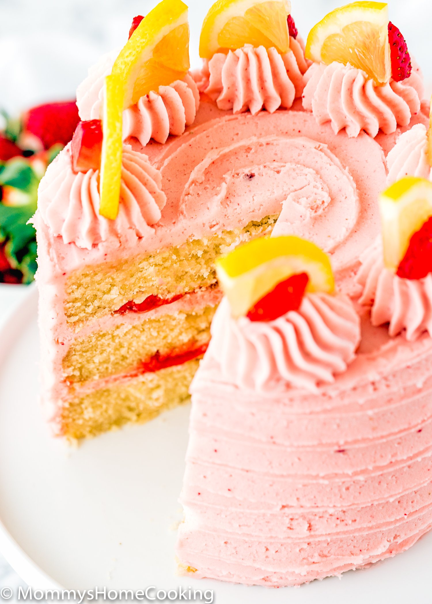 Eggless Strawberry Lemonade Cake cut and showing fluffy inside texture.
