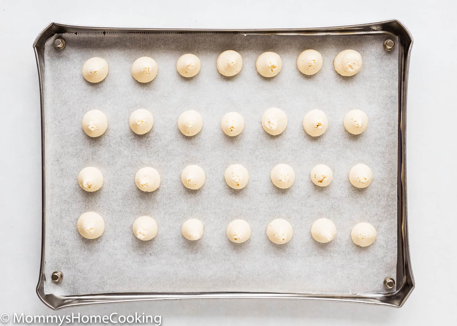 Eggless Vanilla Wafers dough scoop out in a baking tray.