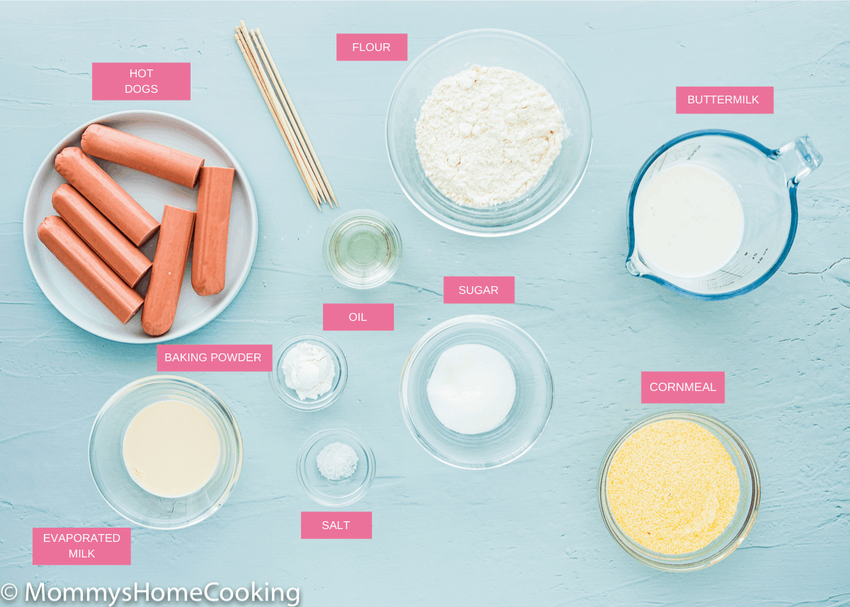 ingredients needed to make Eggless Corndogs over a blue table with tag names.
