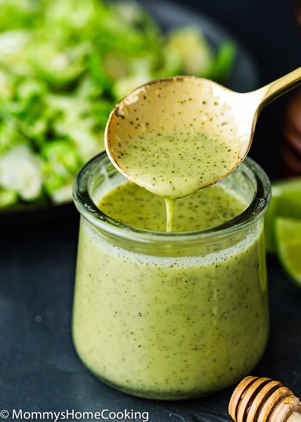 Green onion vinaigrette in a container with a spoon
