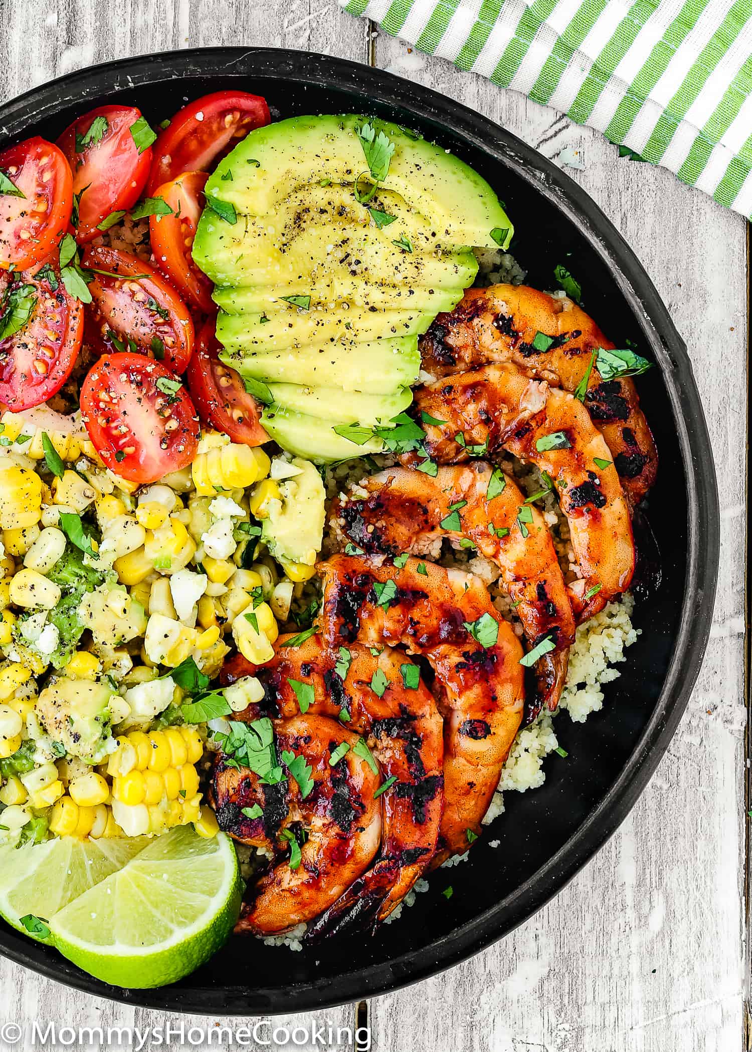 This Grilled Barbecue Shrimp and Corn Avocado Salad Bowls recipe is delicious, incredibly tasty and ridiculously easy to make! Perfectly tender and juicy jumbo shrimp glazed with barbecue sauce, couscous, corn avocado salad, tomatoes, make a perfect summer meal, don't you think? https://mommyshomecooking.com
