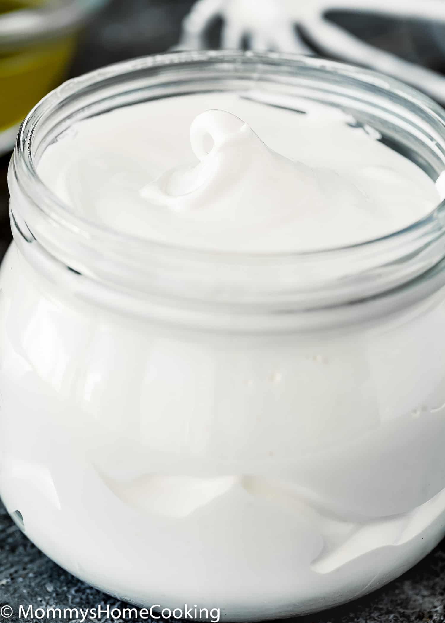 a glass jar filled with Homemade Eggless Marshmallow Fluff.