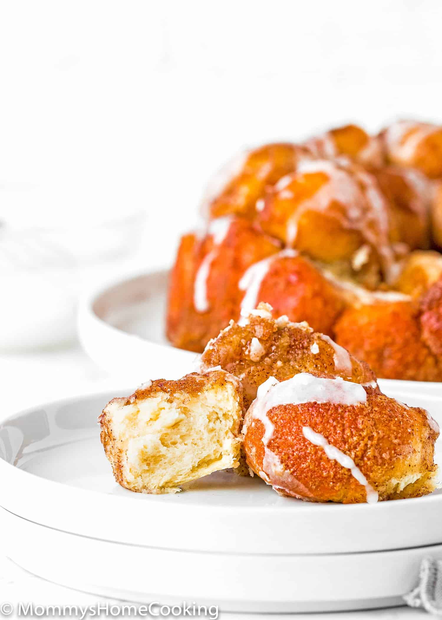 Homemade Eggless Monkey Bread pieces showing the fluffy inside texture on a plate. 