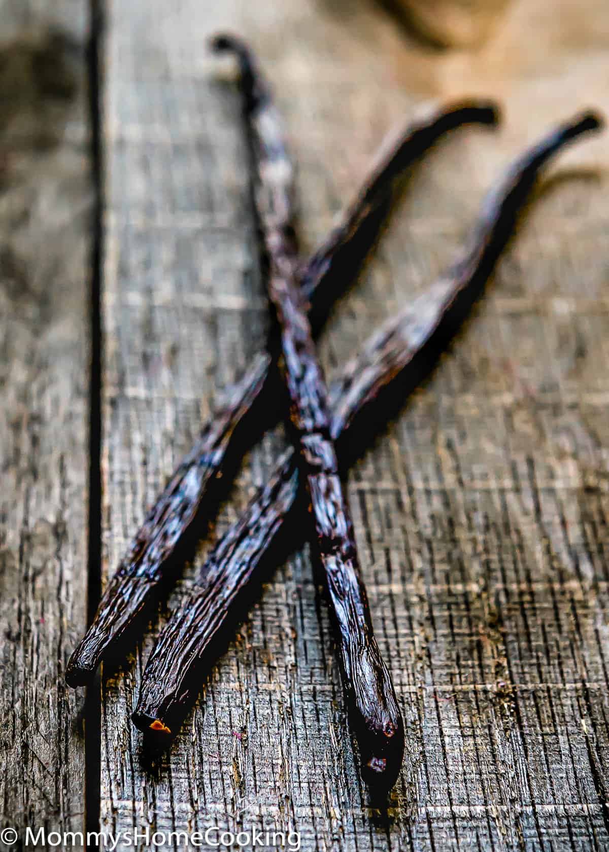 vanilla beans over a wooden surface