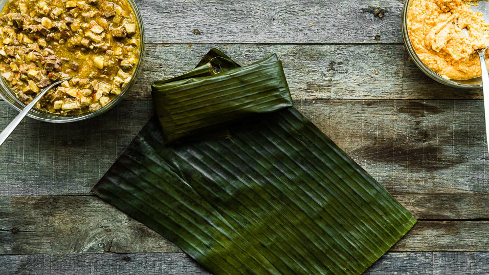 a wrapped Hallaca over a wooden surface.