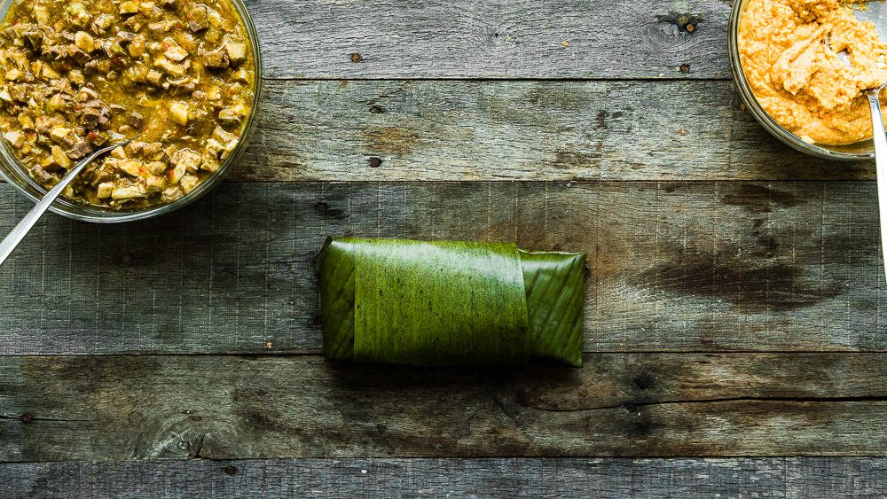 a wrapped Hallaca over a wooden surface.