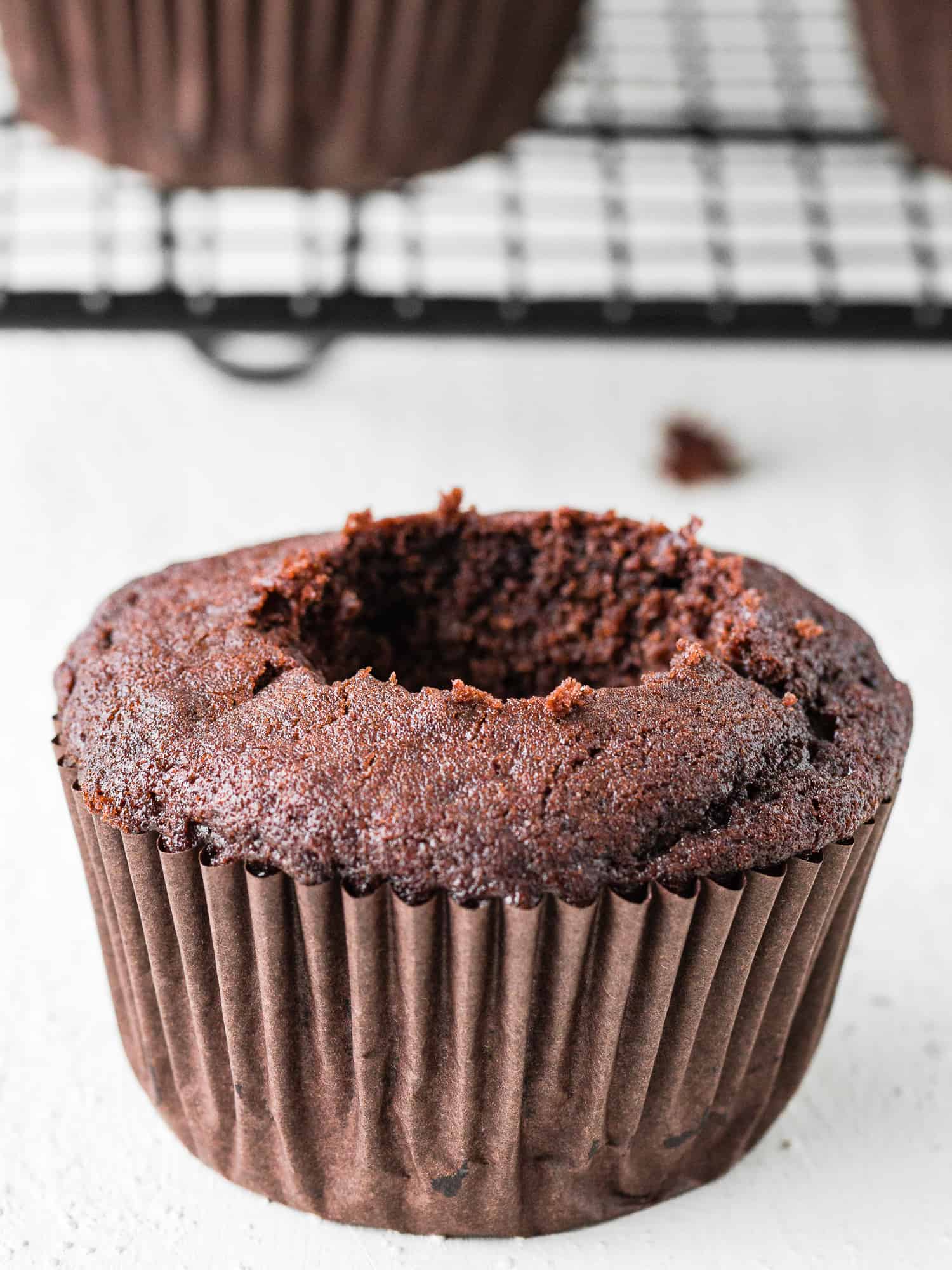 an eggless chocolate cupcakes with a hold in the center. 