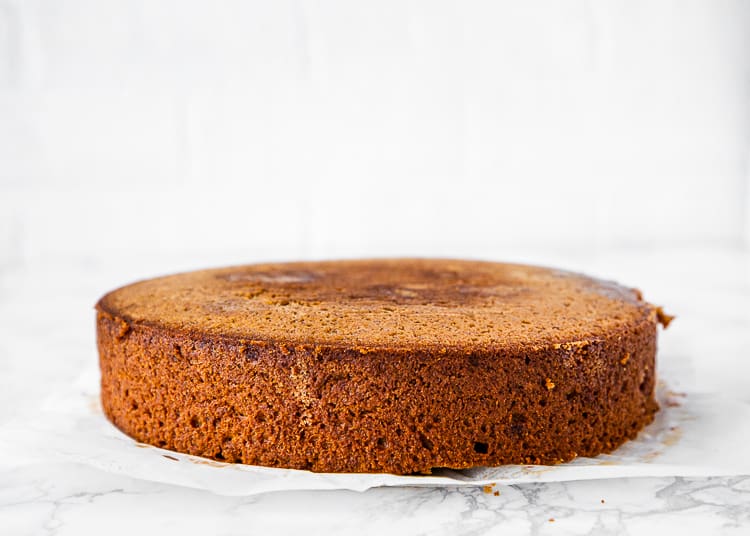 unfrosted egg-free banana cake over a marble surface. 