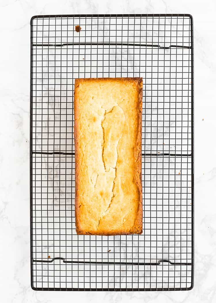 baked egg-free lemon pound cake over a cooling rack. 