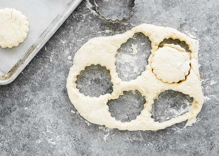 eggless homemade biscuits dough cut into circles. 