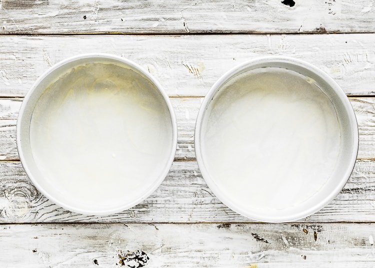 two round cake pan over a wooden surface. 