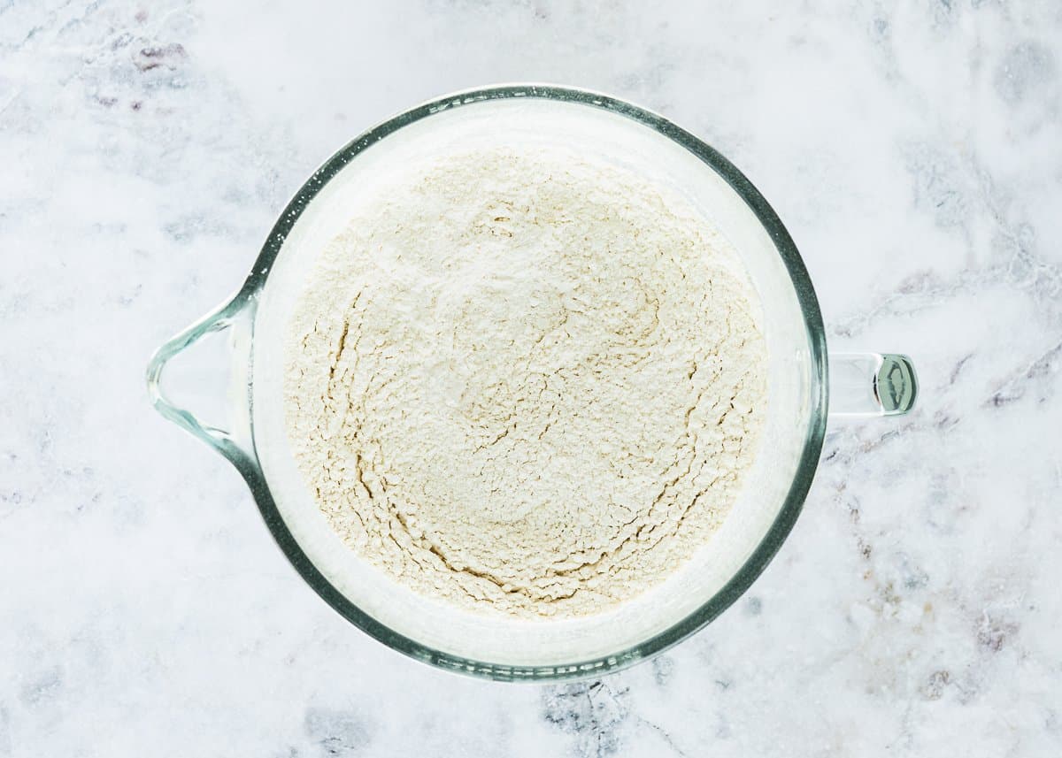 dry ingredients needed to make egg-free brioche mix together  in a stand mixer bowl.