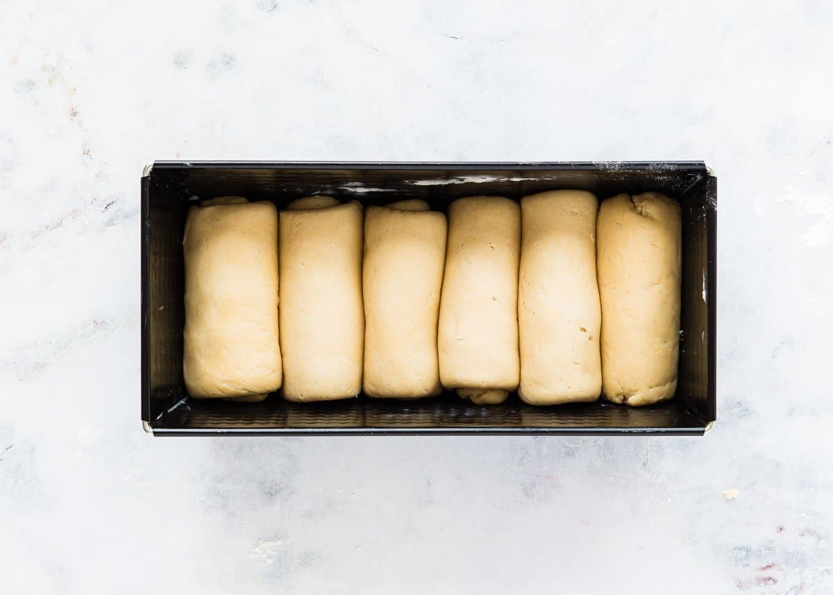 a un baked letter fold egg-free brioche loaf in a loaf pan. 