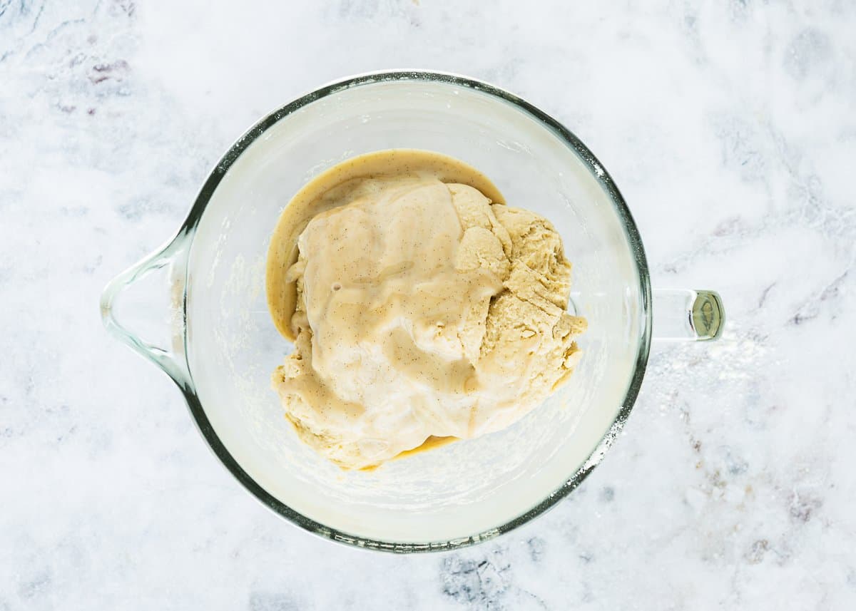 egg- brioche dough in a bowl with condensed milk on top. 