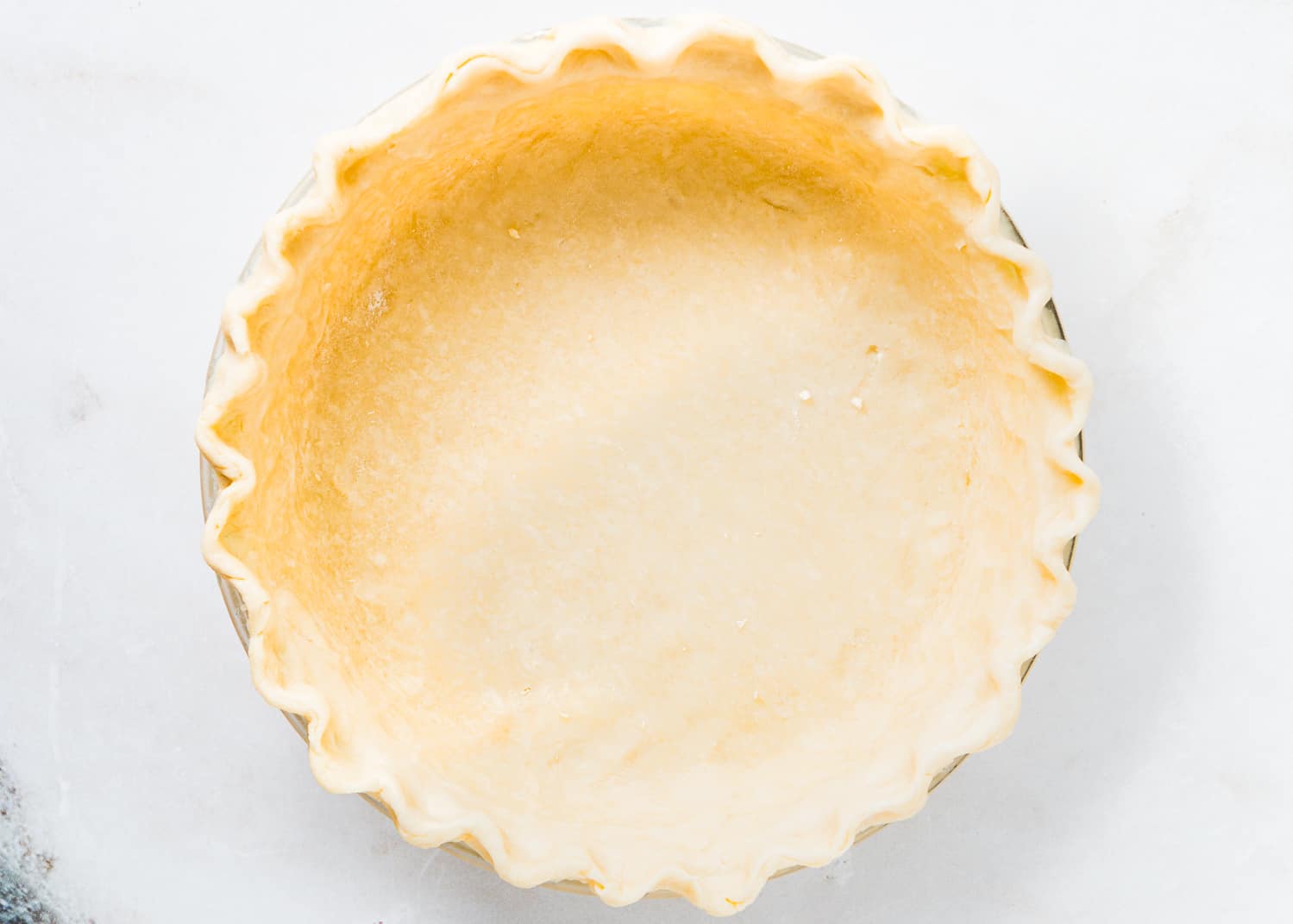 unbaked pie crust in a pie dish. 