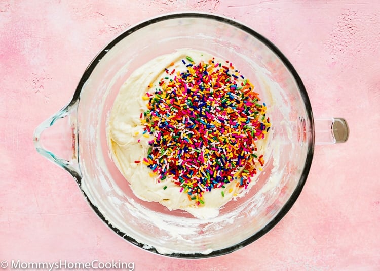 egg-free cupcakes batter in a stand mixer bowl with sprinkles on top.