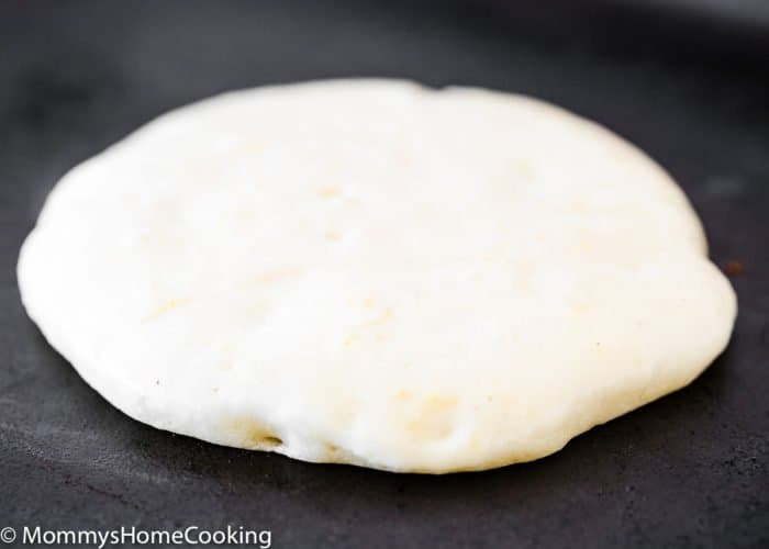 a pancakes being cooked in a griddle. 