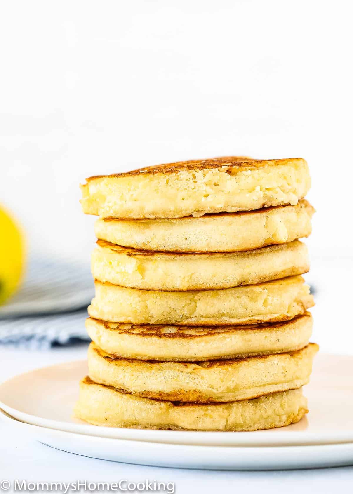 stack of eggless lemon Ricotta pancakes on a plate .