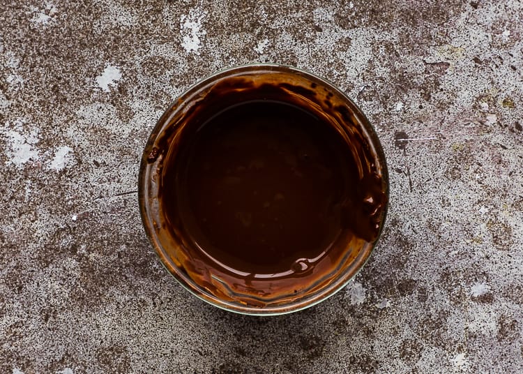 cocoa, hot water, and espresso powder mixed together in a bowl.