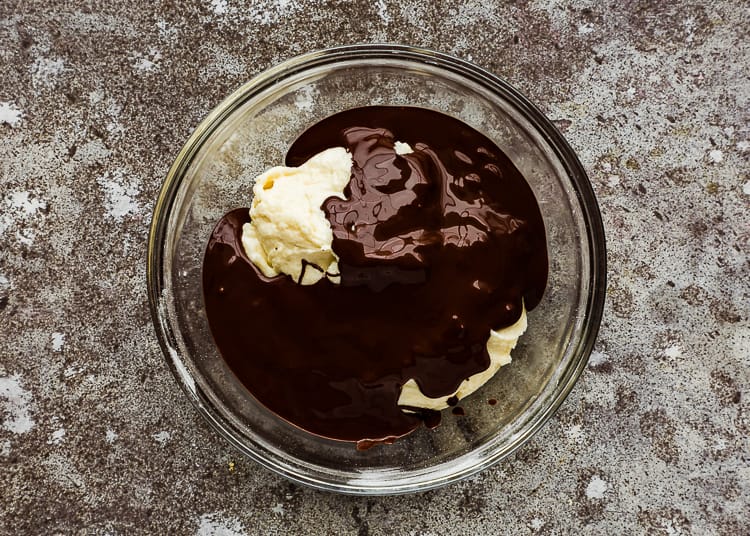 egg-free cake batter in a bowl with cocoa mixture on top. 