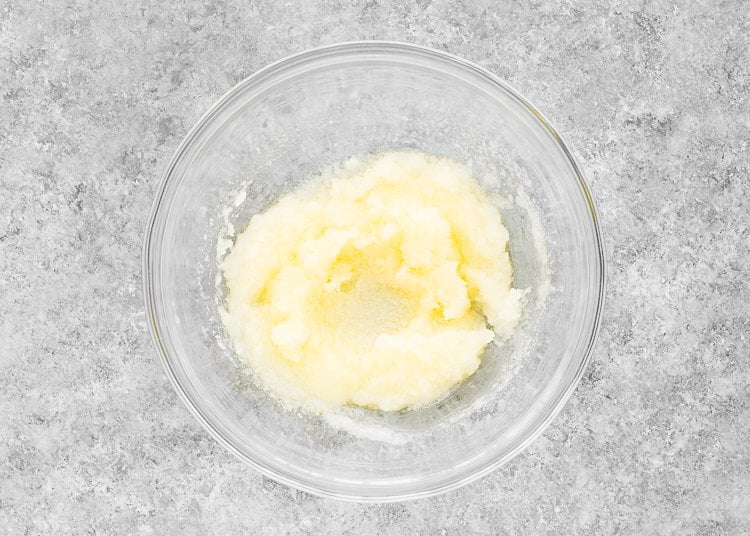 melted butter and sugar mixed together in a bowl. 