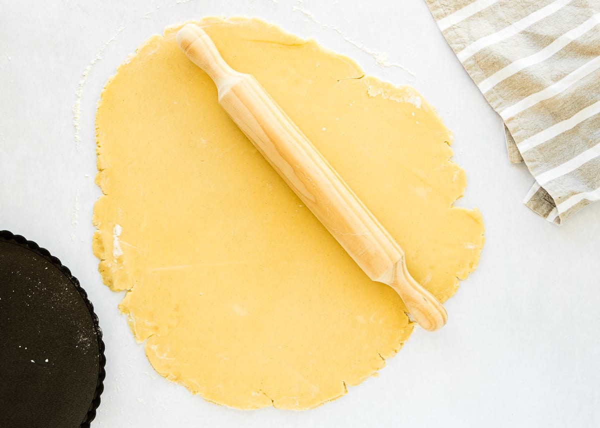 a rolled out eggless tart dough on a floured surface. 