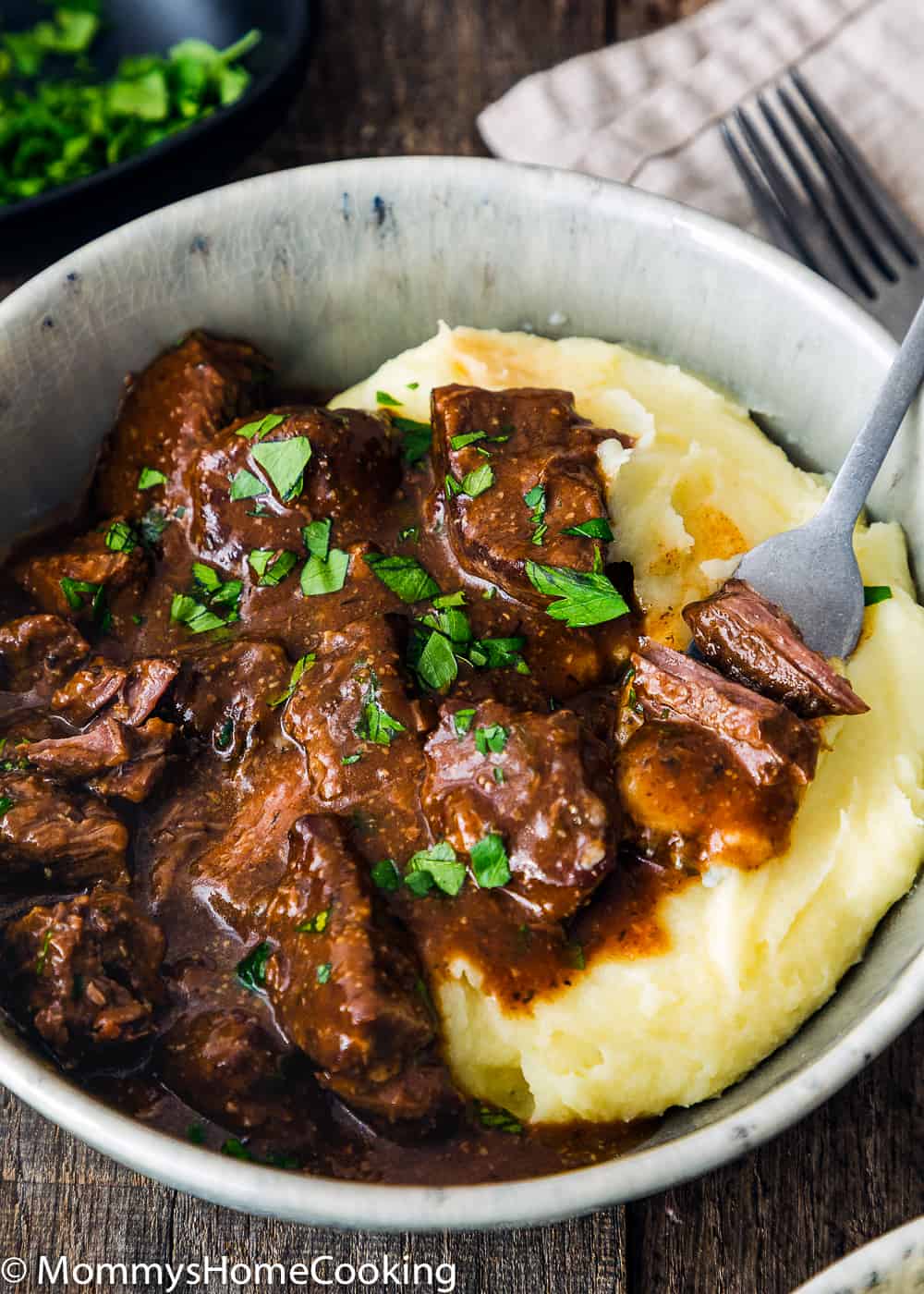 Pot Beef Tips with Gravy and mashed potatoes in a bowl with a fork