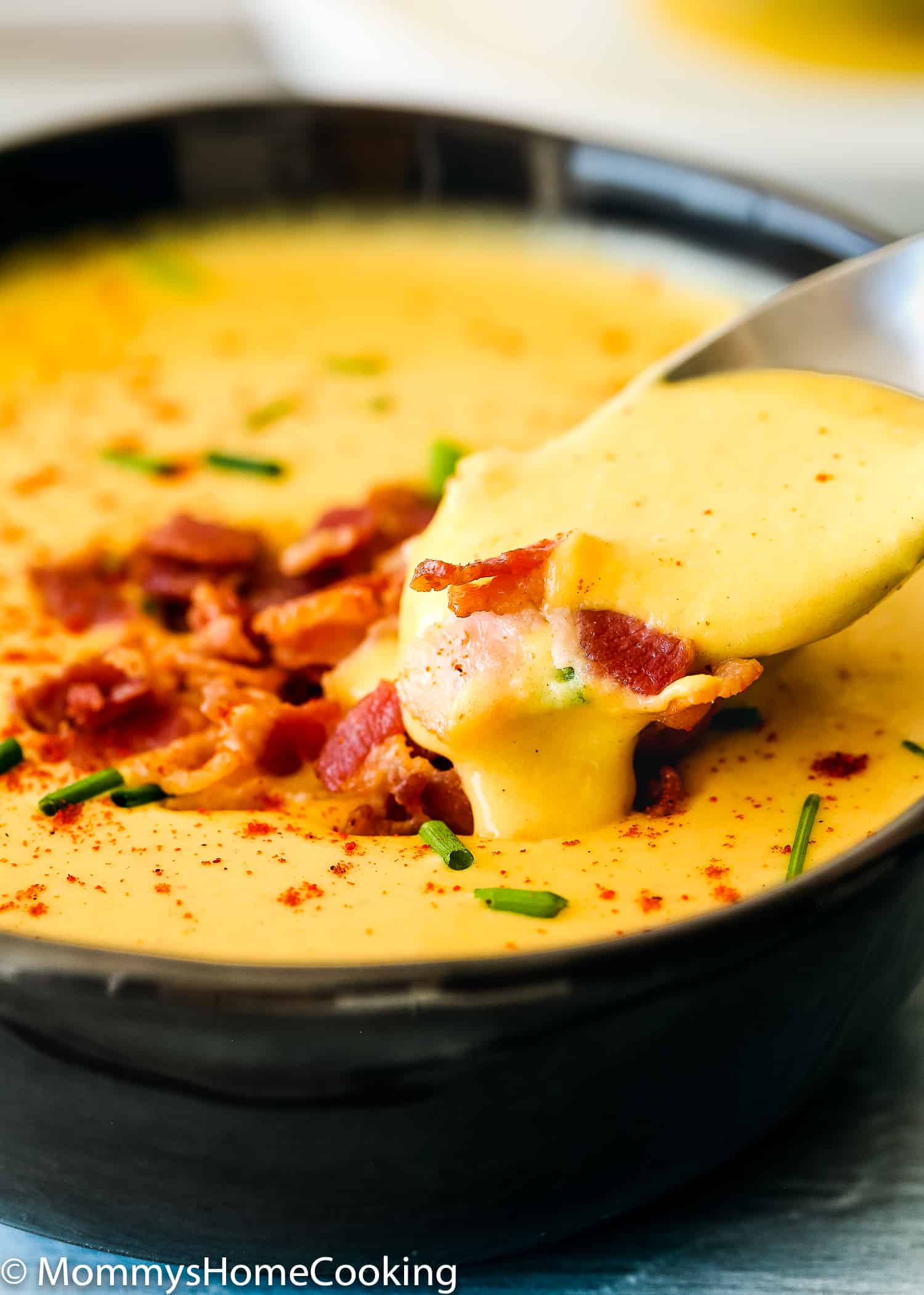 Smoky Cheese and Potato Soup in a bowl with a spoon