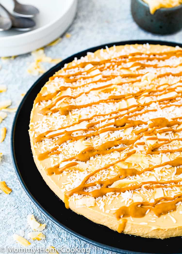 No-Bake Eggless Dulce de Leche Cheesecake with coconut flakes and dulce de leche drizzle 