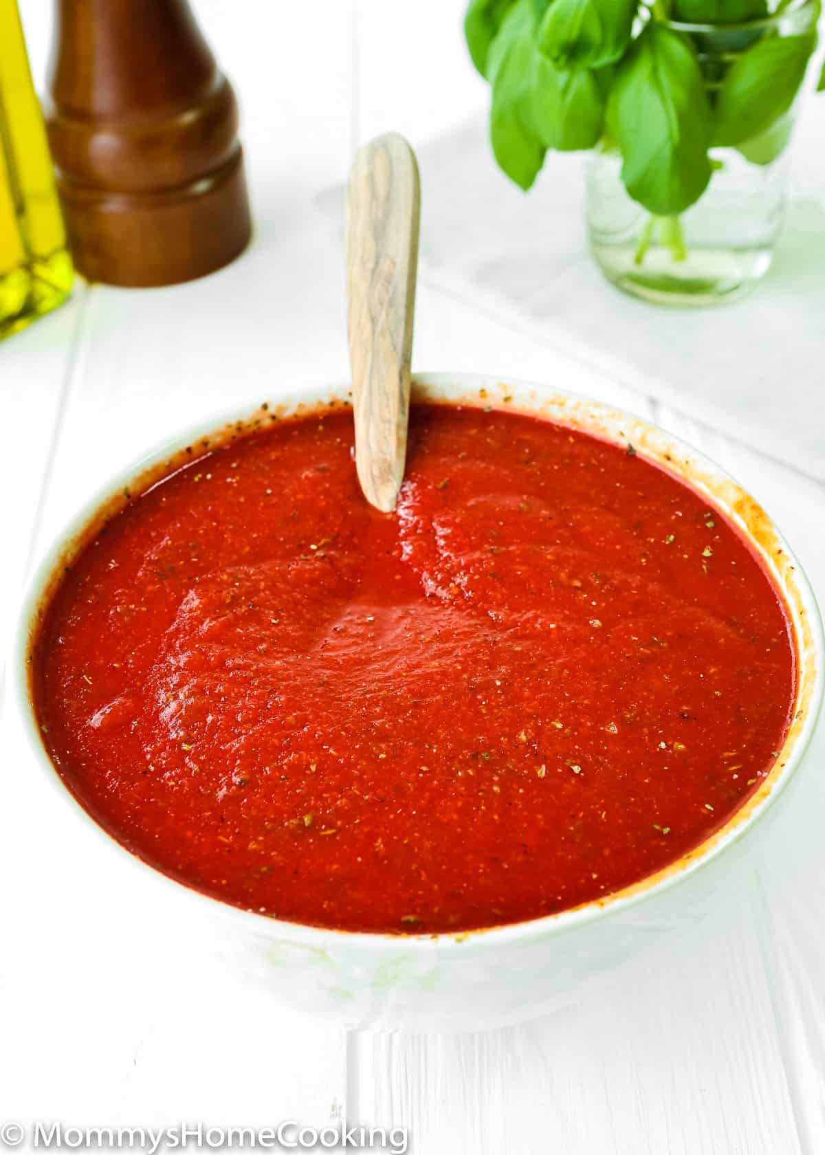 No-Cook Easy Pizza Tomato Sauce in a bowl with a spoon.