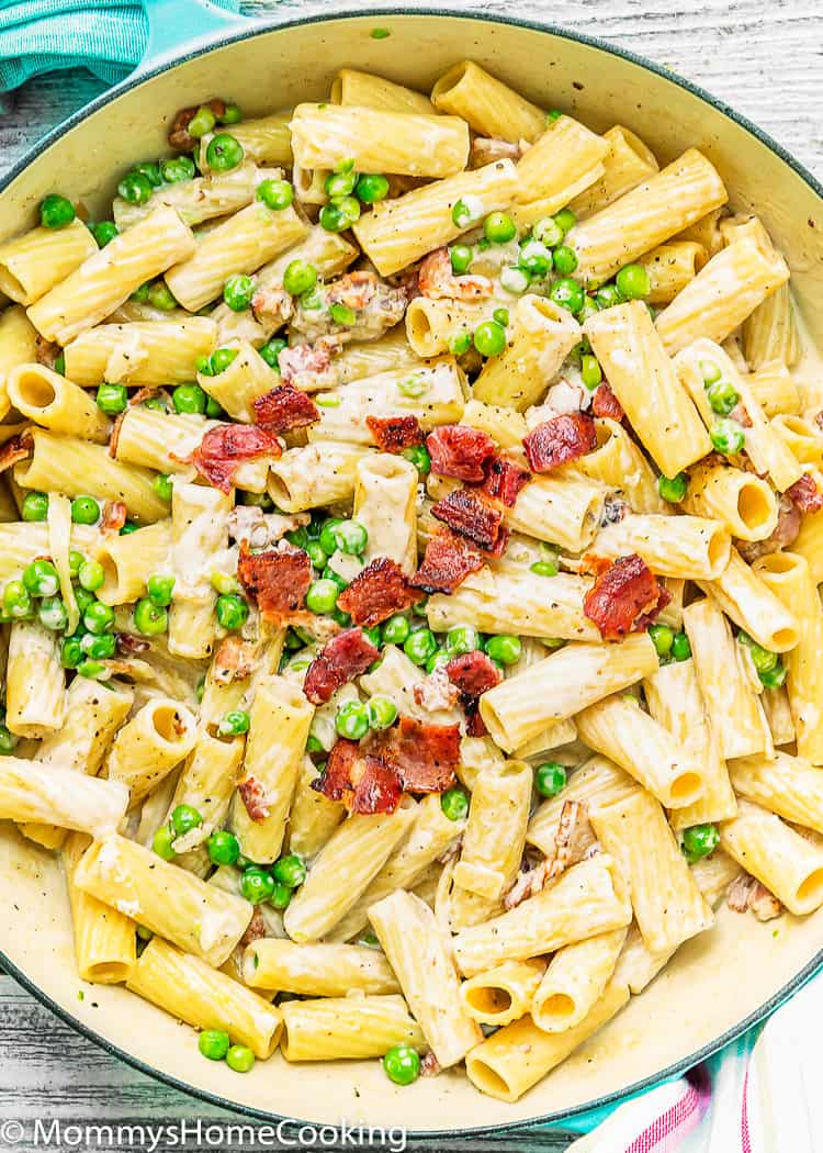 Easy Creamy Alfredo Pasta with Bacon and Peas in a pot with crumbled crispy bacon