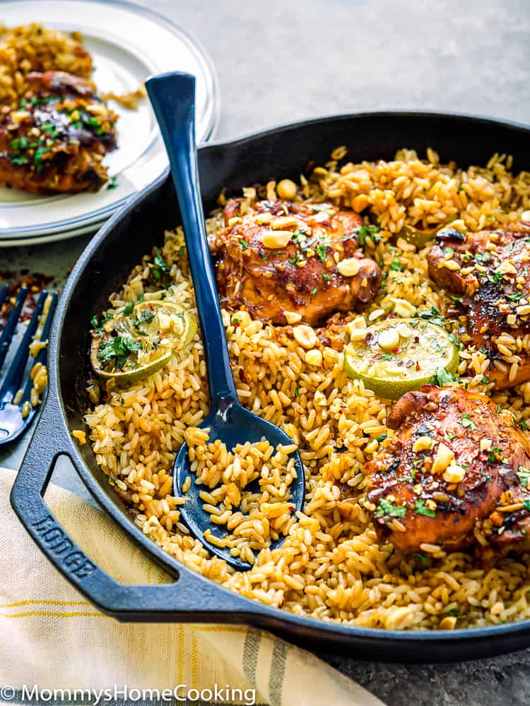 skillet with thai rice and chicken and a serving spoon