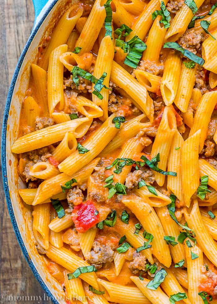 Big skillet with Penne with Sausage and Spicy Cream Tomato Sauce close-up