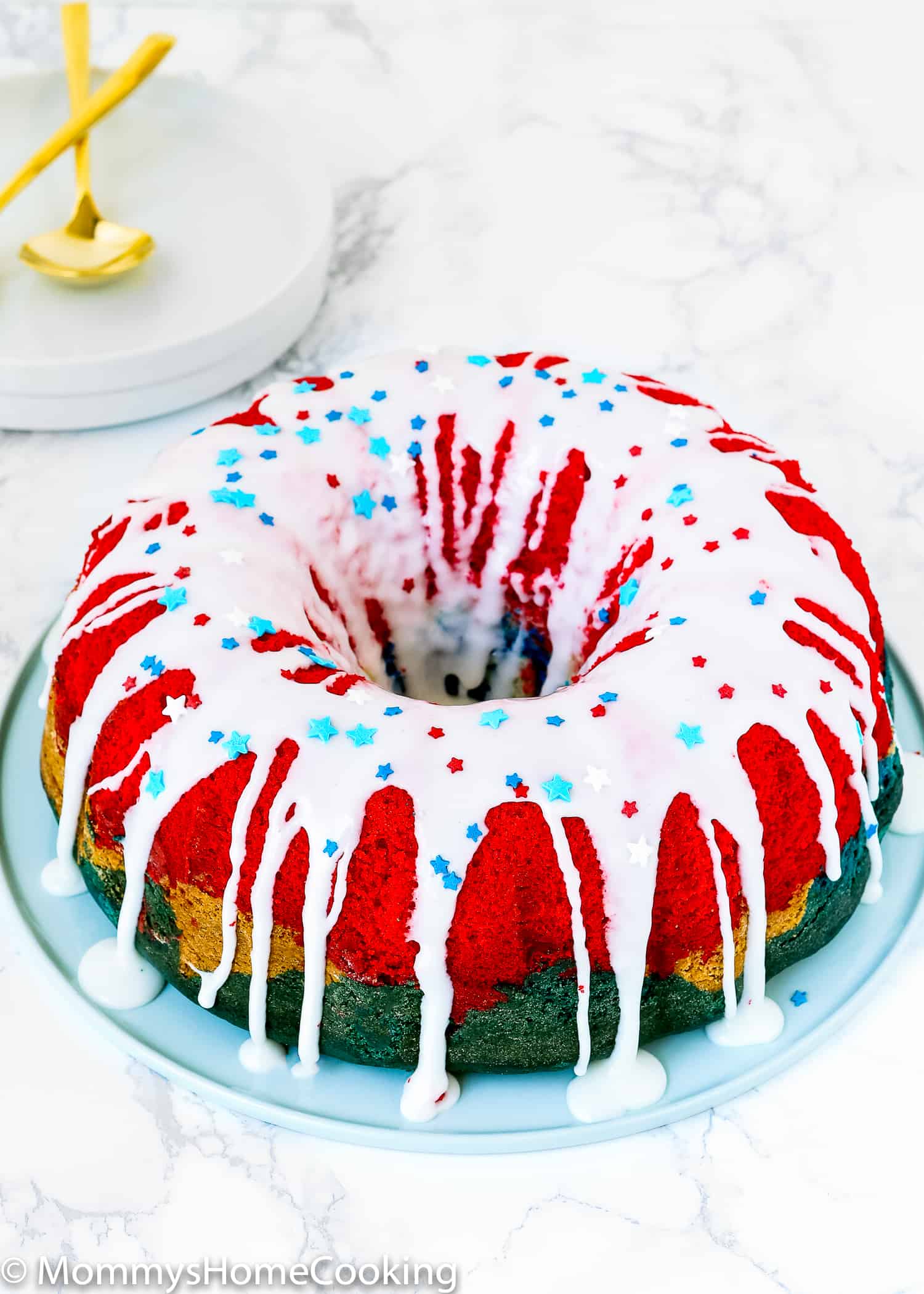Red, White, and Blue Eggless Bundt Cake with glaze on top.