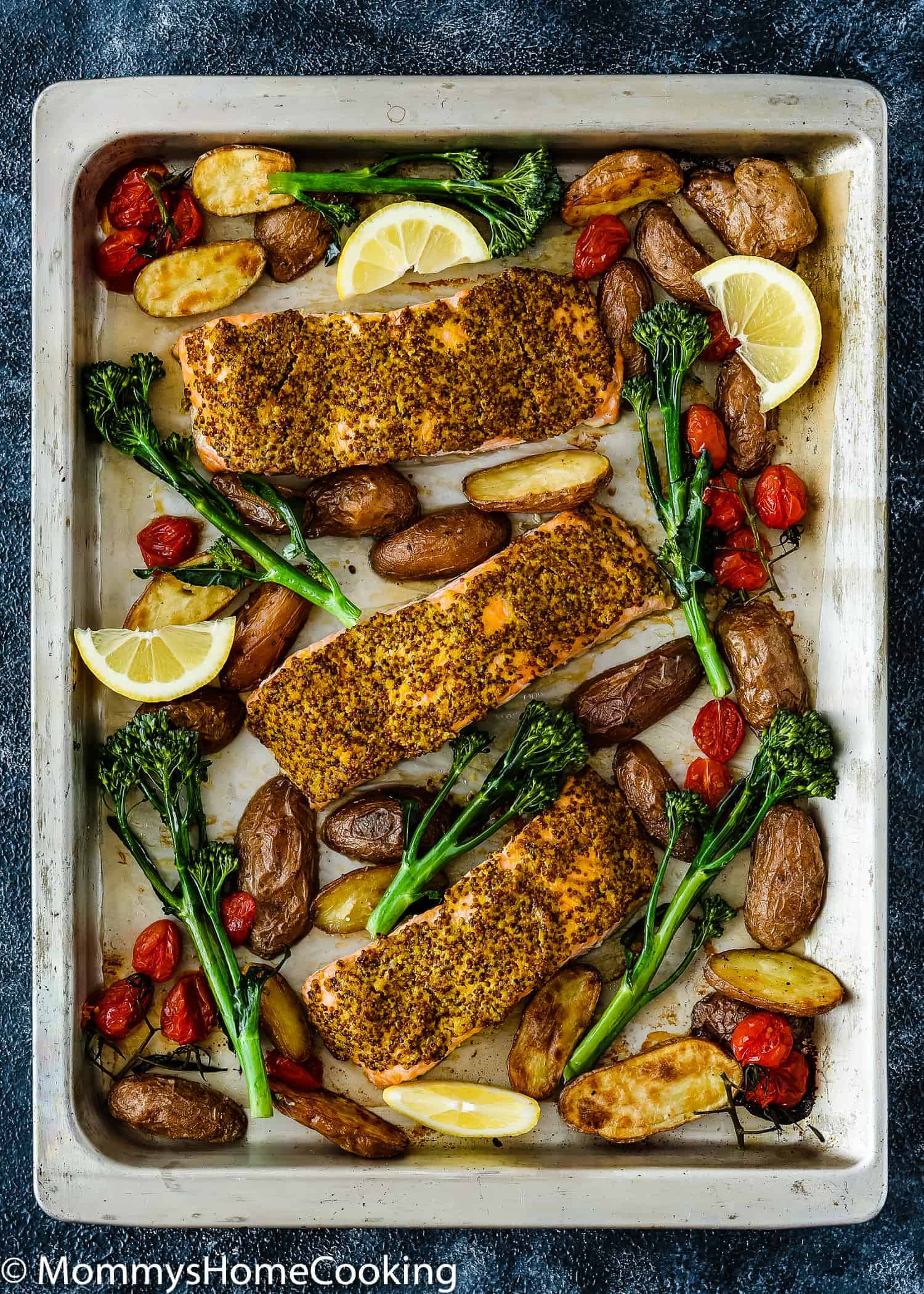 Sheet Pan with Salmon Filets, roasted potatoes, tomatoes.