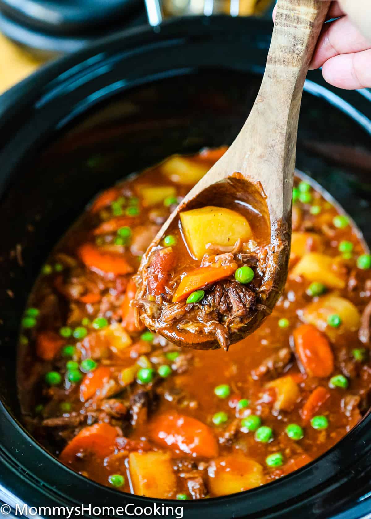 a serving spoon with Slow Cooker Oxtail Stew