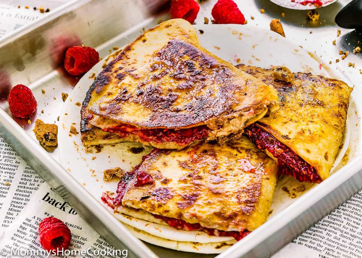 Wedges of Sweet Raspberry Chocolate Chip Quesadilla with fresh raspberries 