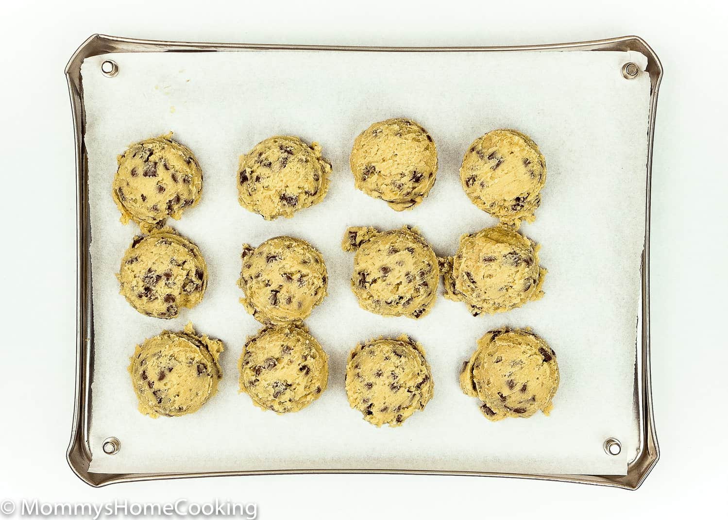 egg-free chocolate chip cookie dough balls on a baking tray. 