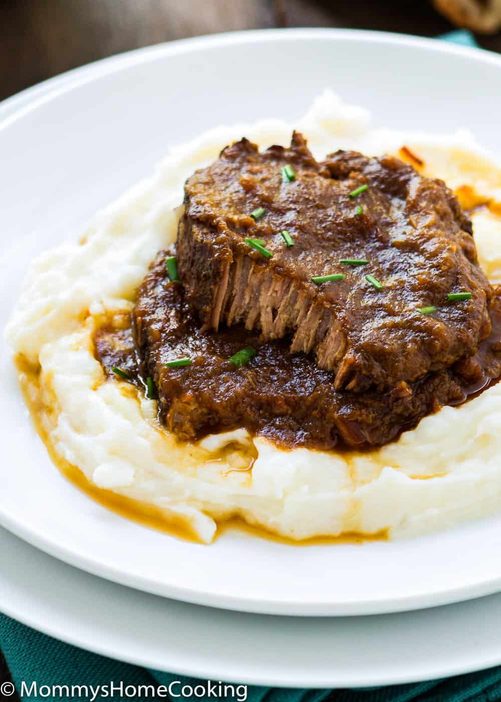 Asado Negro in a white plate with mashed potatoes  and sauce