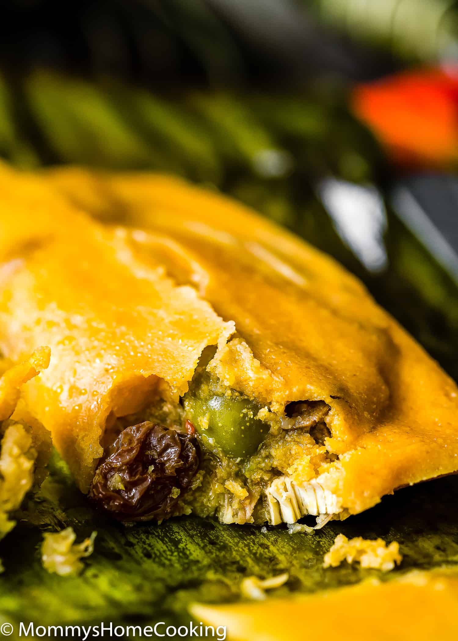 closeup view of the inside of a hallaca over a plantain leave.