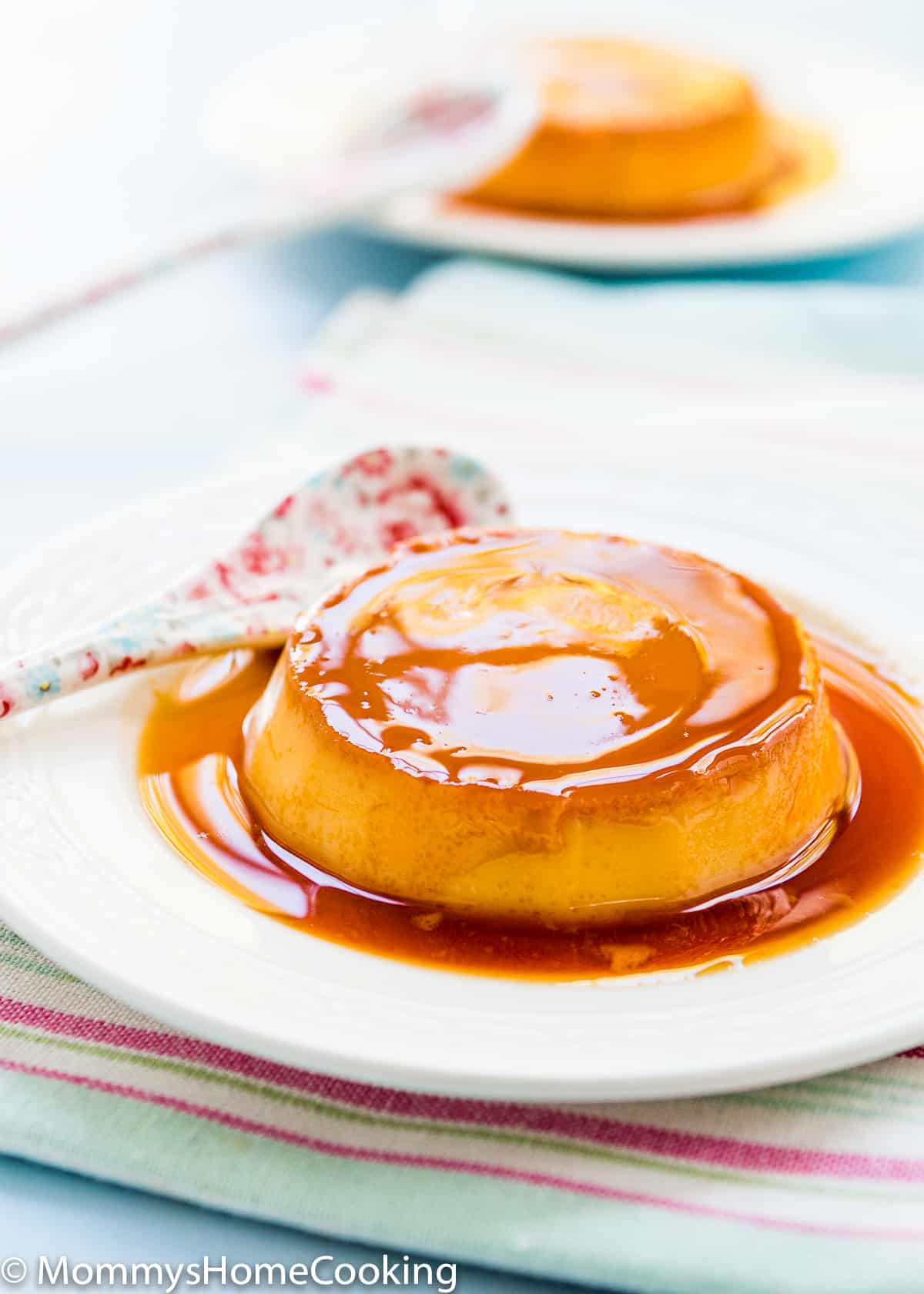 Venezuelan Quesillo with caramel sauce on a plate with a spoon