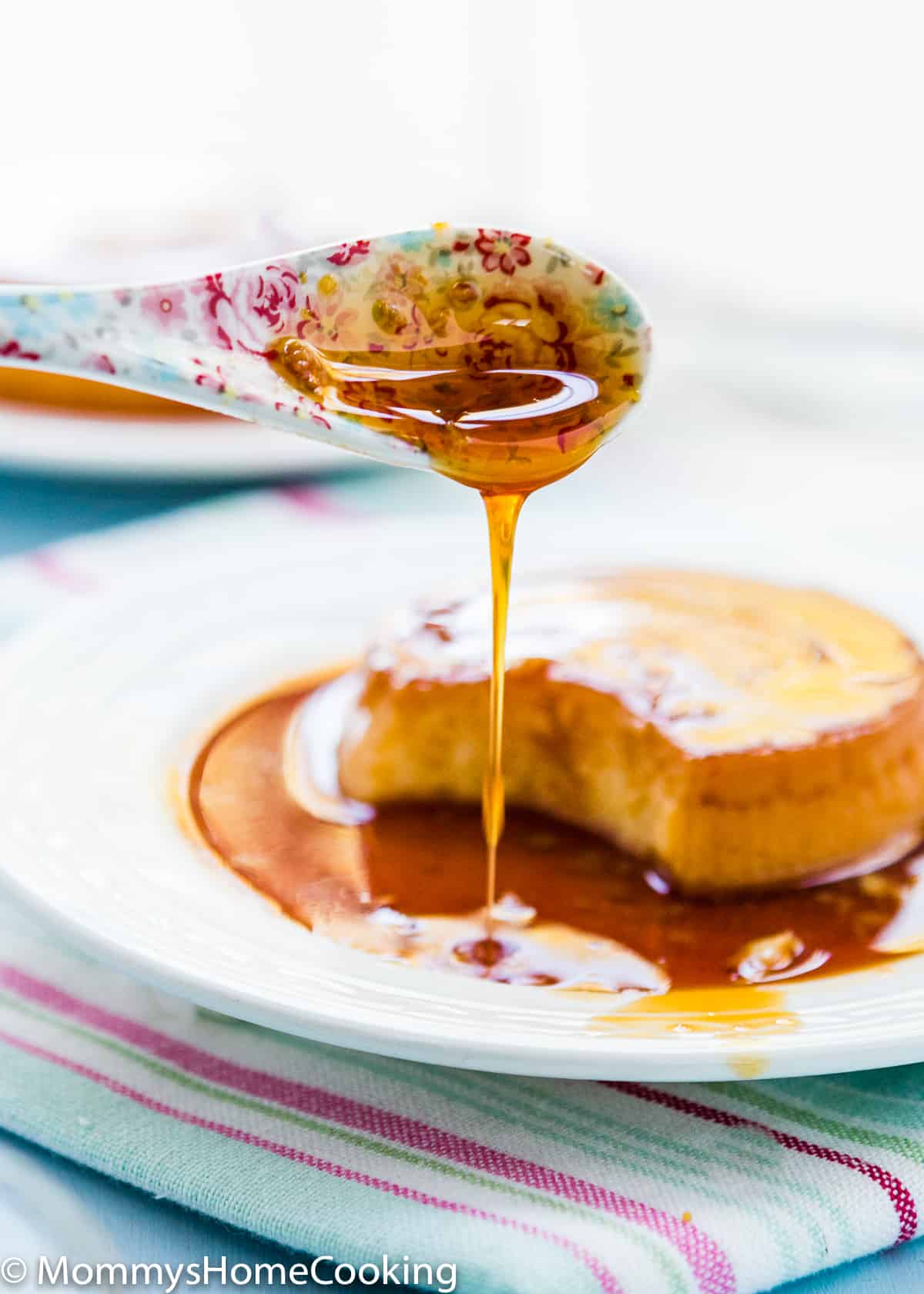 spoon pouring quesillo caramel sauce