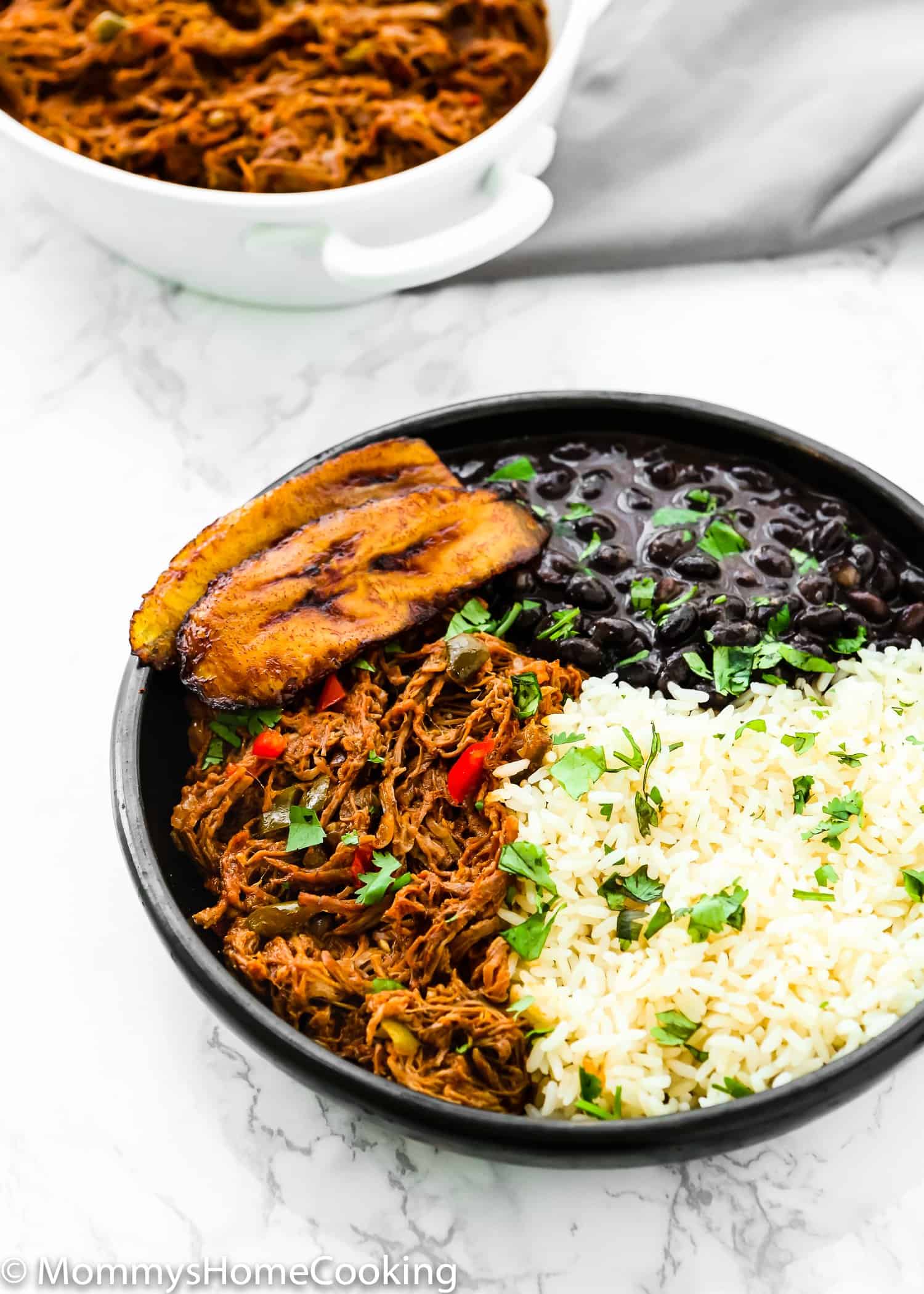 Venezuelan Shredded Beef on a plate with beans and rice for Pabellon Criollo.